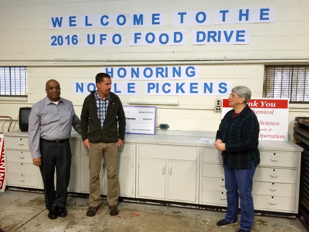 Andy Altman, center, explains Dow Chemical Company's support for United Food Operation by providing the building, including all maintenance and utilities.