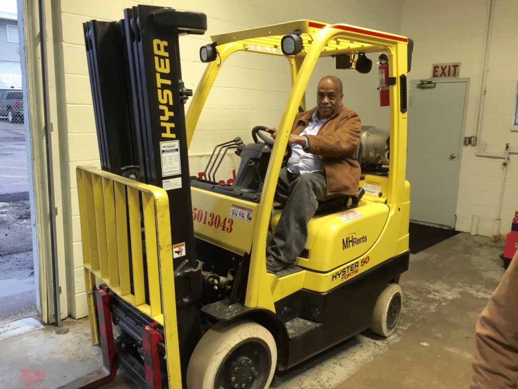 Joe Davenport operates the forklift, donated by MH Rents in Cross Lanes, at the UFO distribution center.