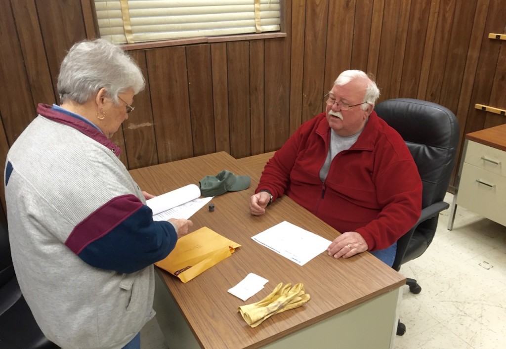 UFO Treasurer Kay Moffat and volunteer Joe Gresham, who supervises food distribution operations at the building, break in the new office space.